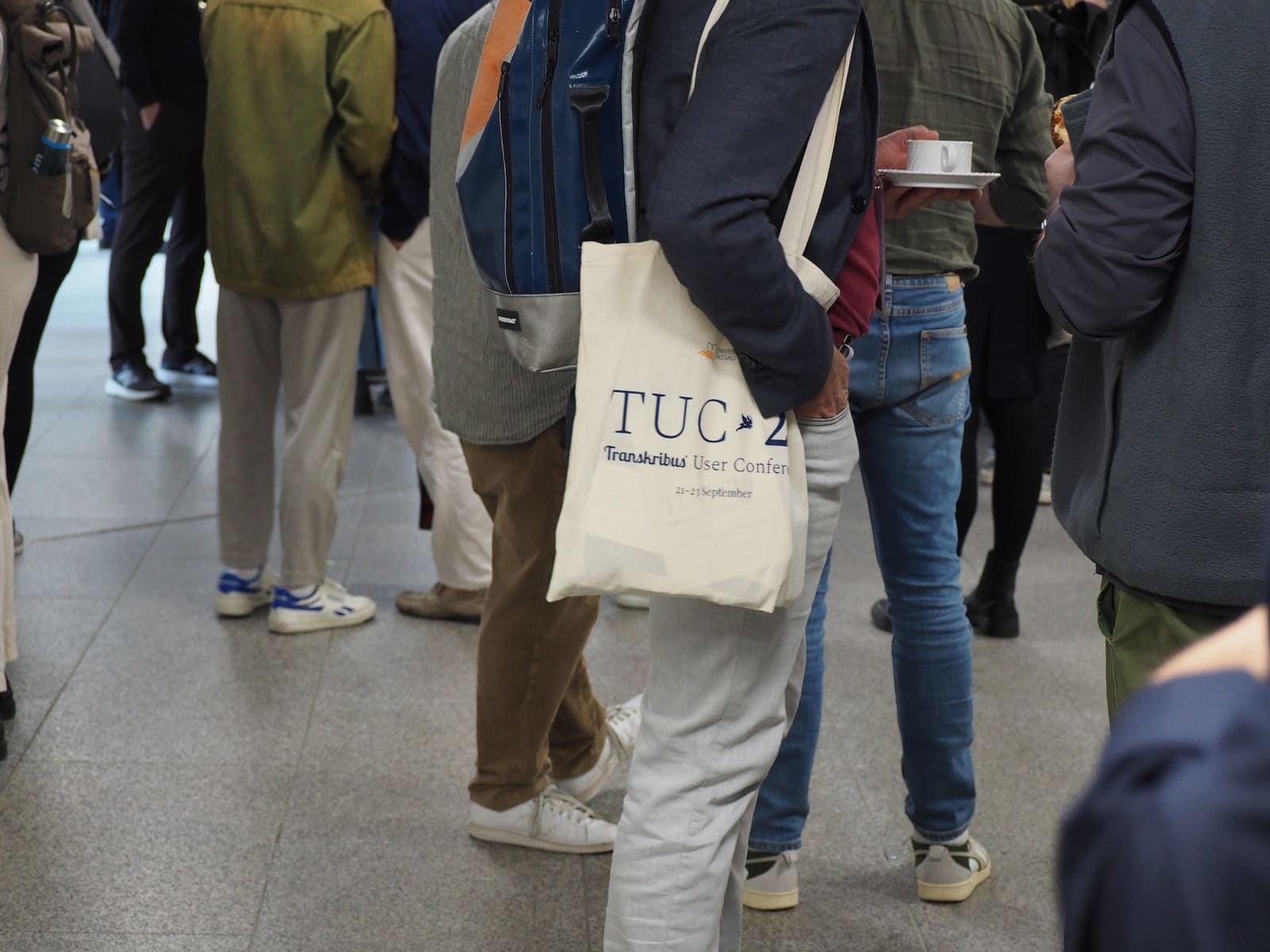 An attendee carrying the TUC 26 conference tote bag